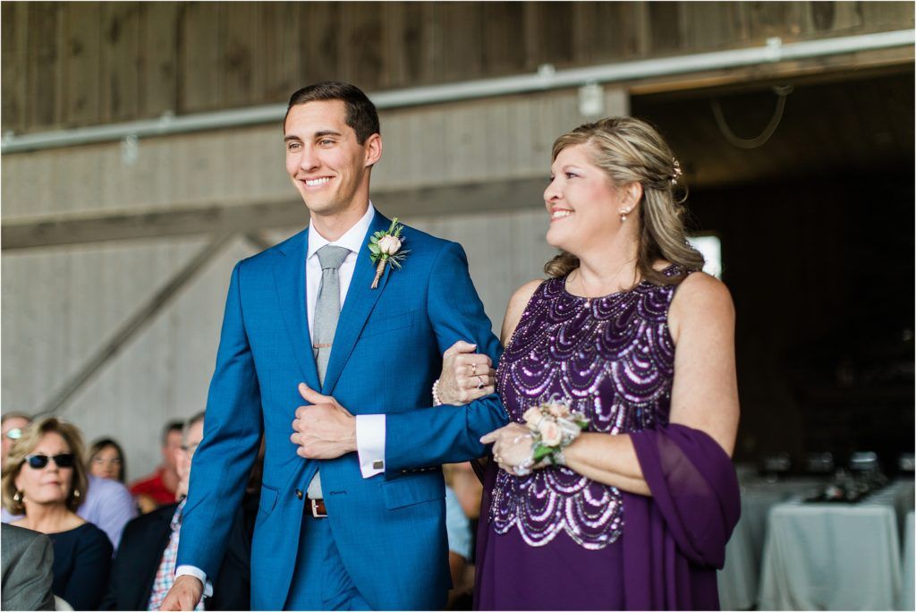Wedding ceremony participants sharing joyful laughter during outdoor celebration.