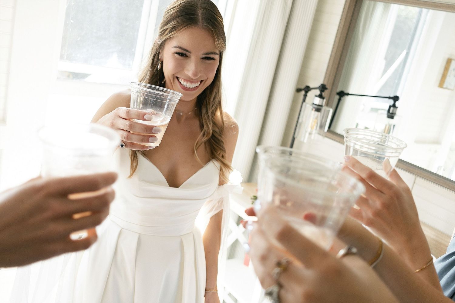 A celebratory toast moment captured during wedding preparations.