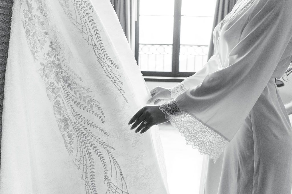Bride inspecting her wedding dress at hotel domestique's bridal suite