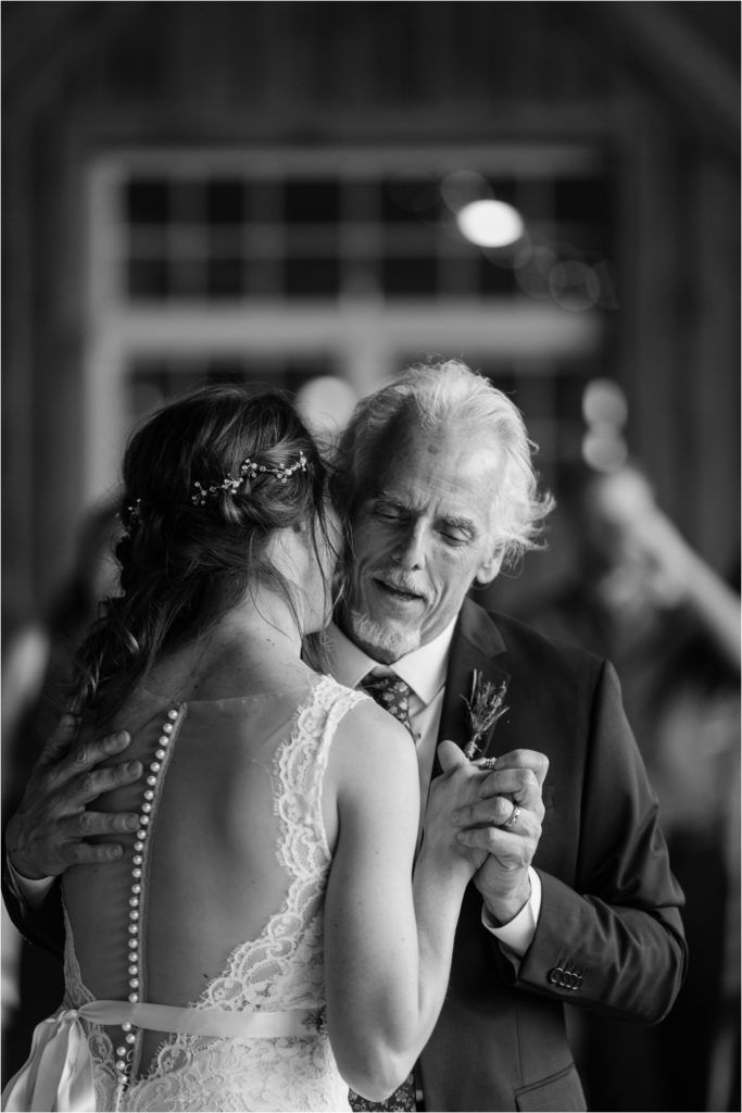 A touching black and white dance moment captured during a wedding celebration.