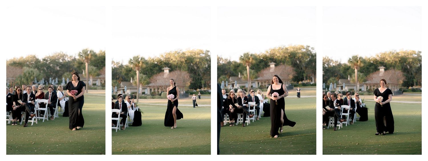 Wedding party members walk in sequence across green lawn during photo session.