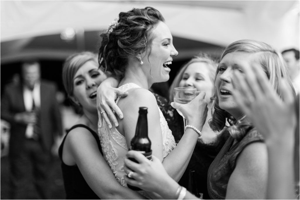 Black and white photo of joyful celebration at wedding reception.