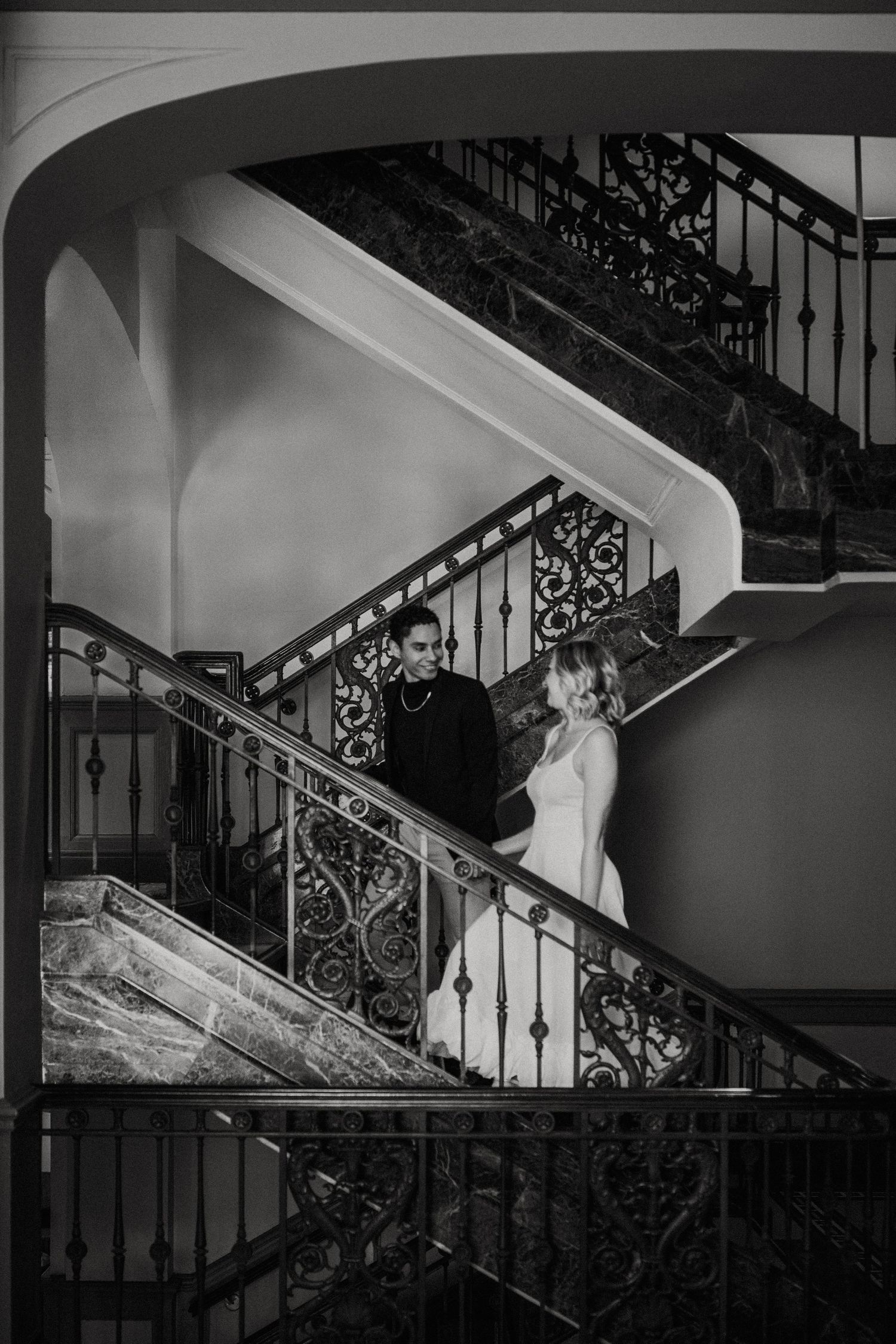 Couple climbing the beautiful 1920s stairs in the Westin poinsett hotel