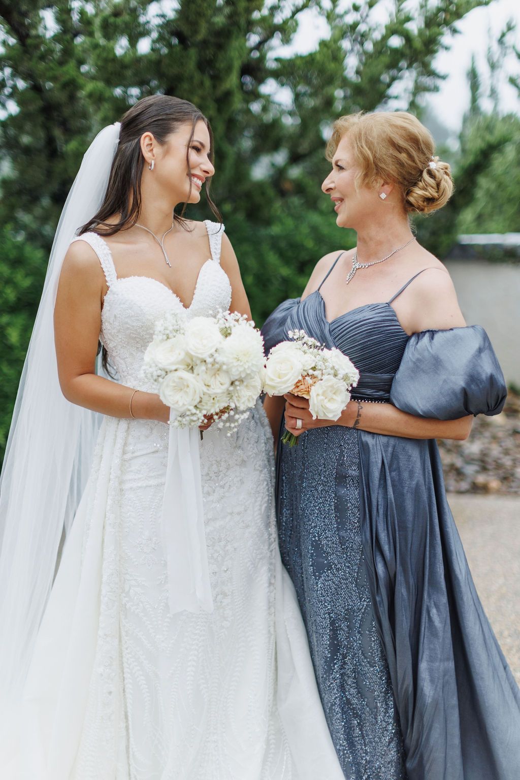 Bride and her mother looking at each other