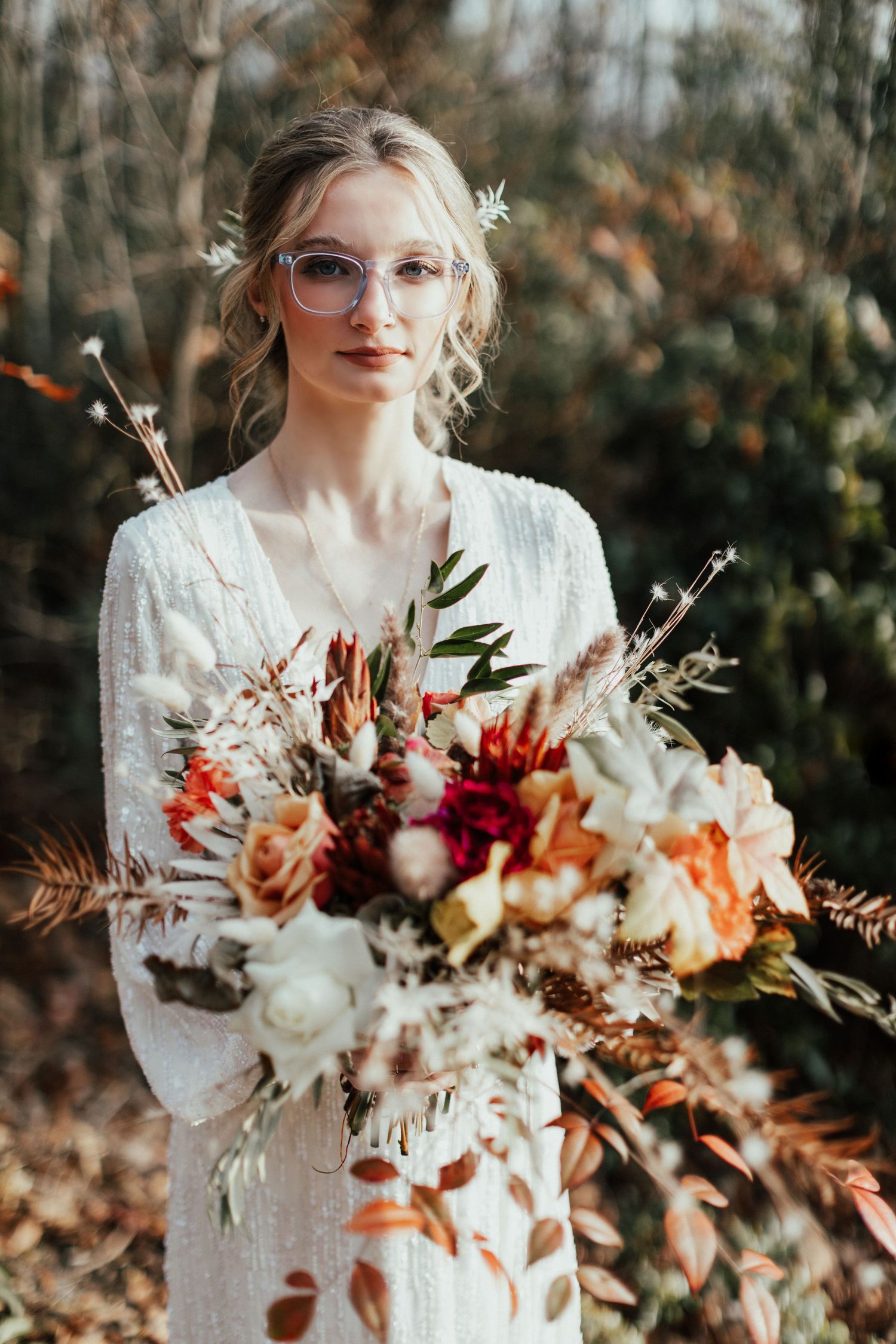 Ethereal bridal portrait with a stunning fall-themed bouquet and vintage-inspired lace dress.