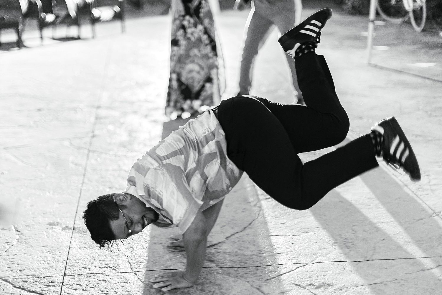 A guest performs an impressive breakdancing move on the dance floor at a wedding reception.