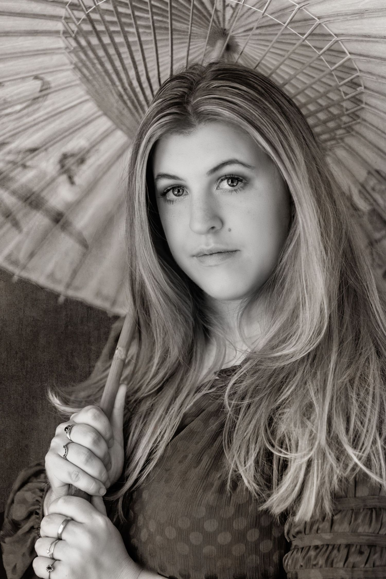 Classic black and white portrait of a blonde woman holding a decorative Asian parasol umbrella.