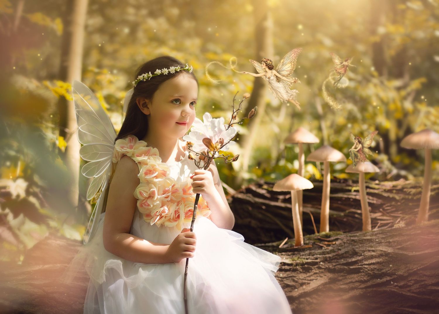 Dreamy young fairy girl in white dress holding wand surrounded by glowing fairies and mushrooms in forest in Birmingham