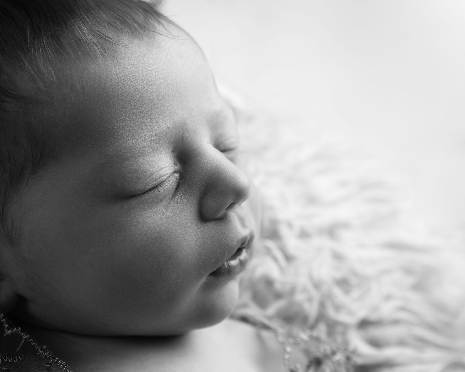Close-up black and white portrait of peaceful sleeping newborn baby  in Birmingham