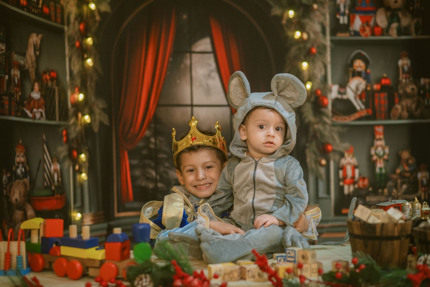 Children in holiday costumes pose among Christmas decorations and nutcrackers in a cozy themed setting.
