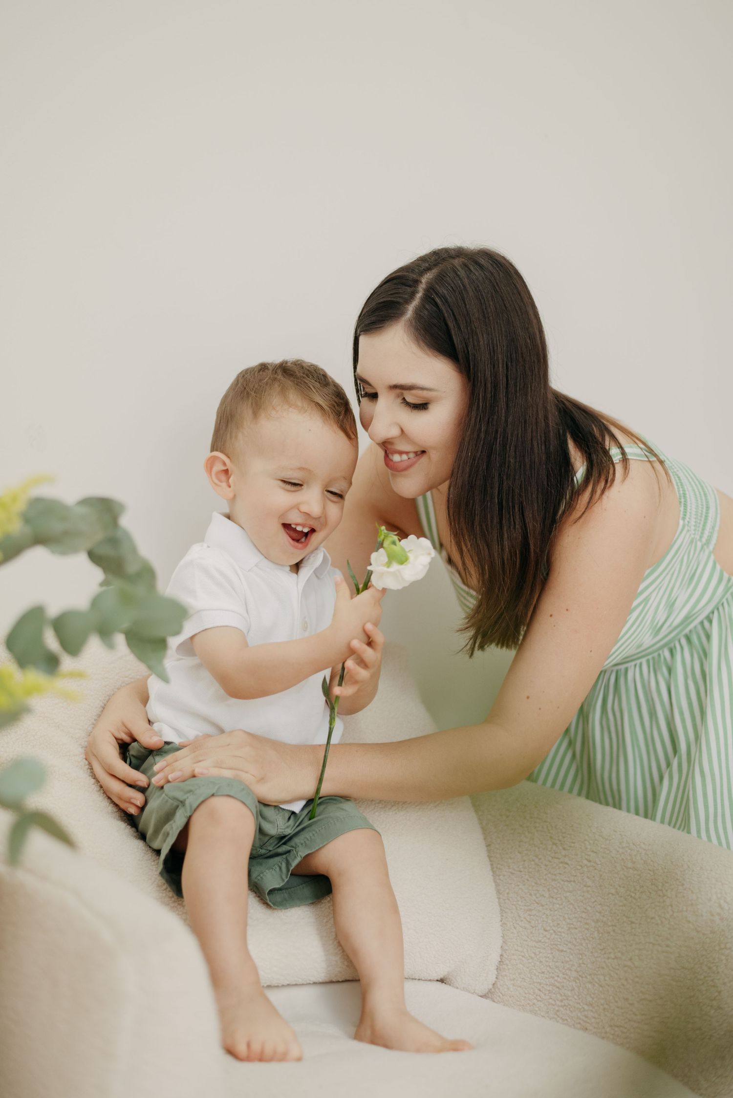 Sweet candid moment showing shared joy and laughter in a bright minimal setting.