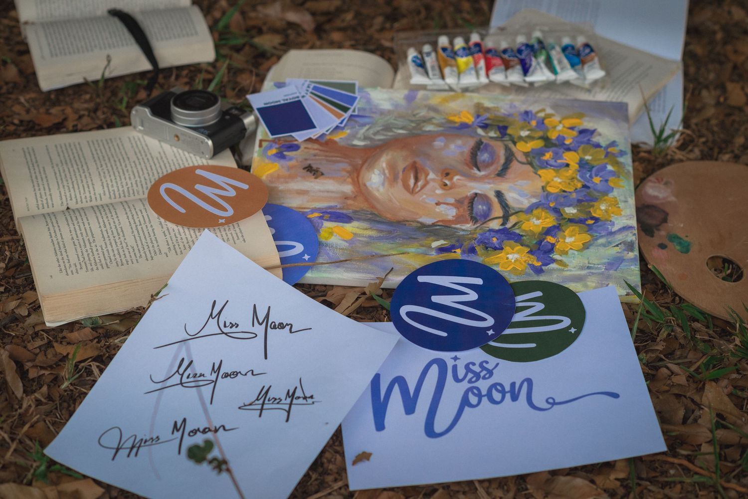 A collection of autographs and memorabilia displayed on a carpet with books and photographs.
