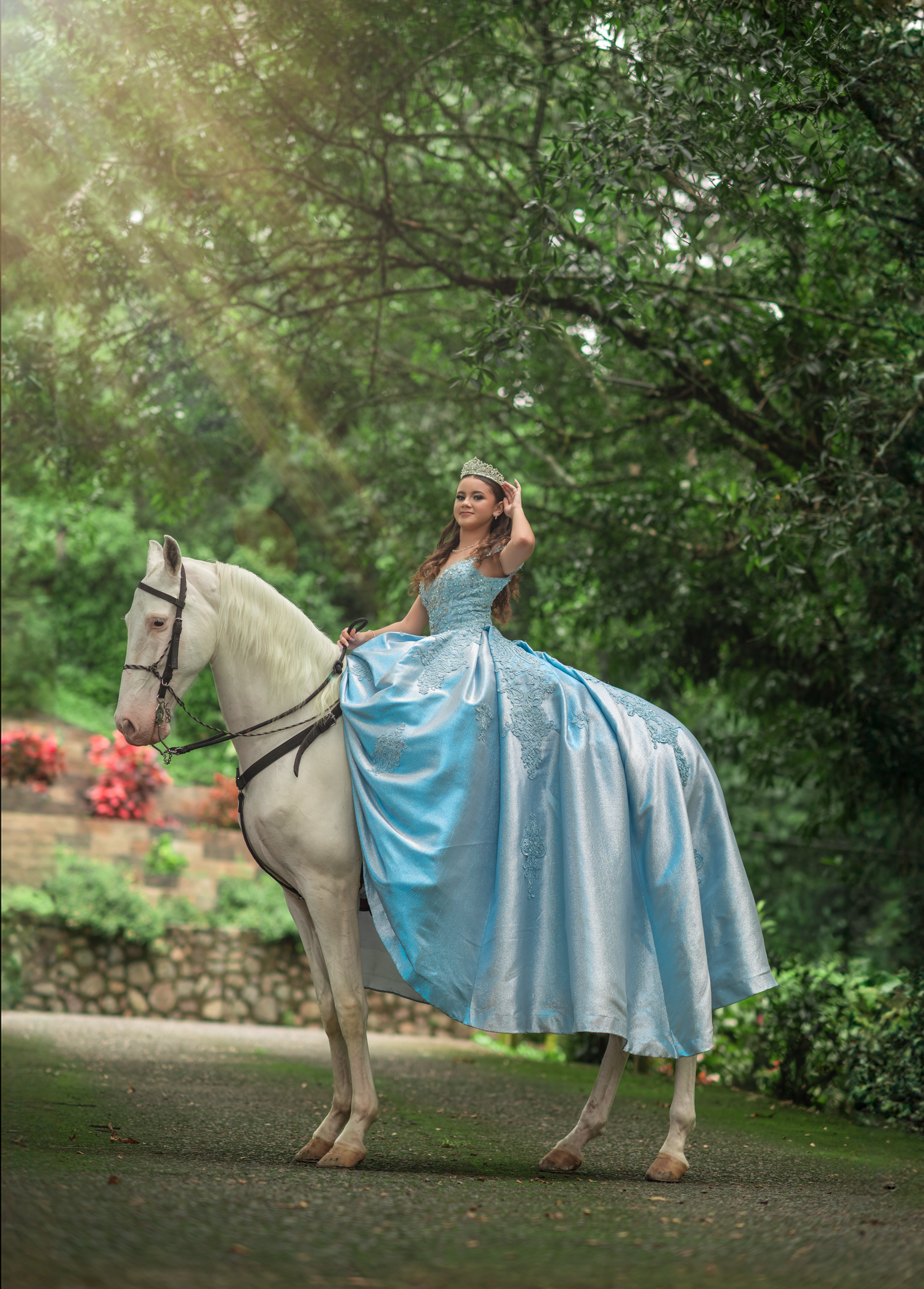 A fairy tale scene with a person in a flowing blue gown riding a white horse through a garden path.