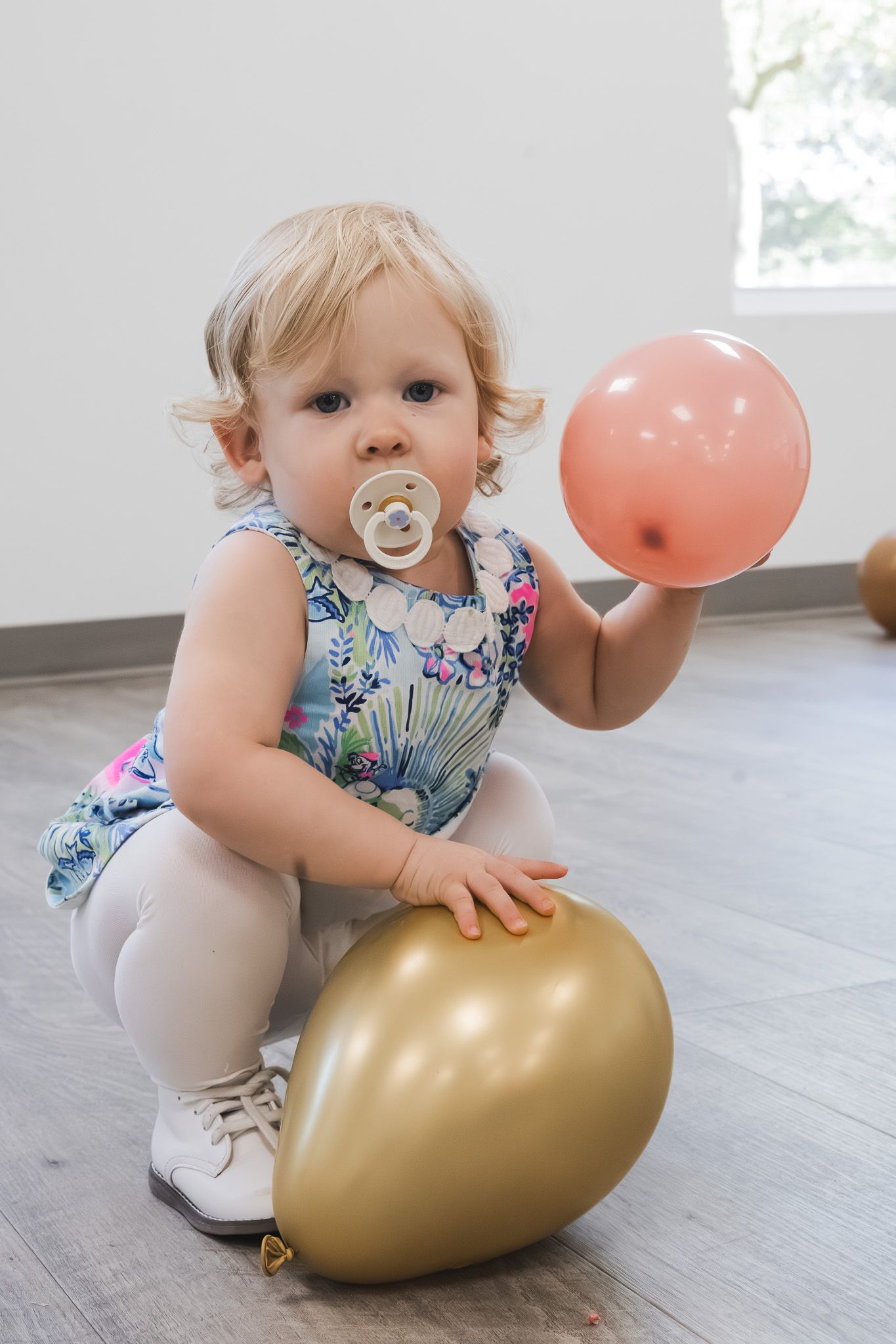 Toddler playing with a balloon at a baby shower in Pensacola, FL