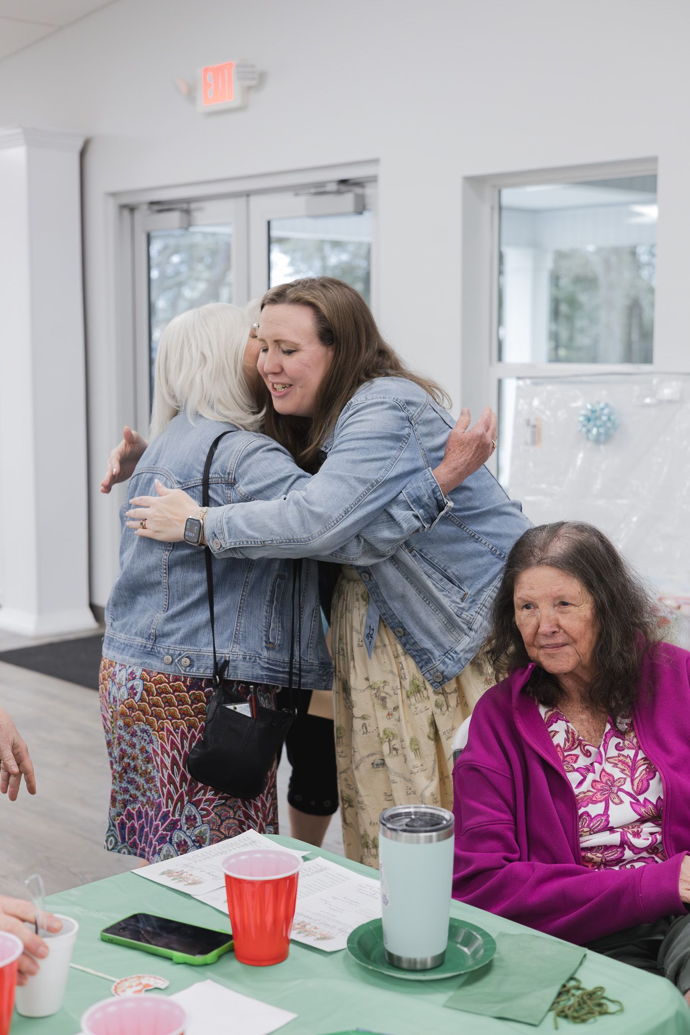 Guests hugging at a baby shower captured by a Pensacola event photographer