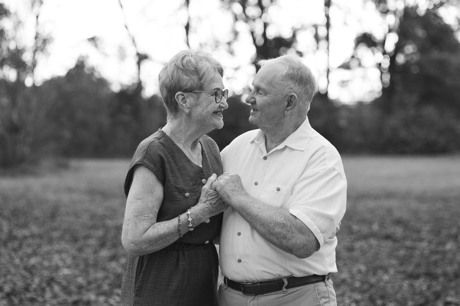 Black and white photo of a senior couple dancing outdoors