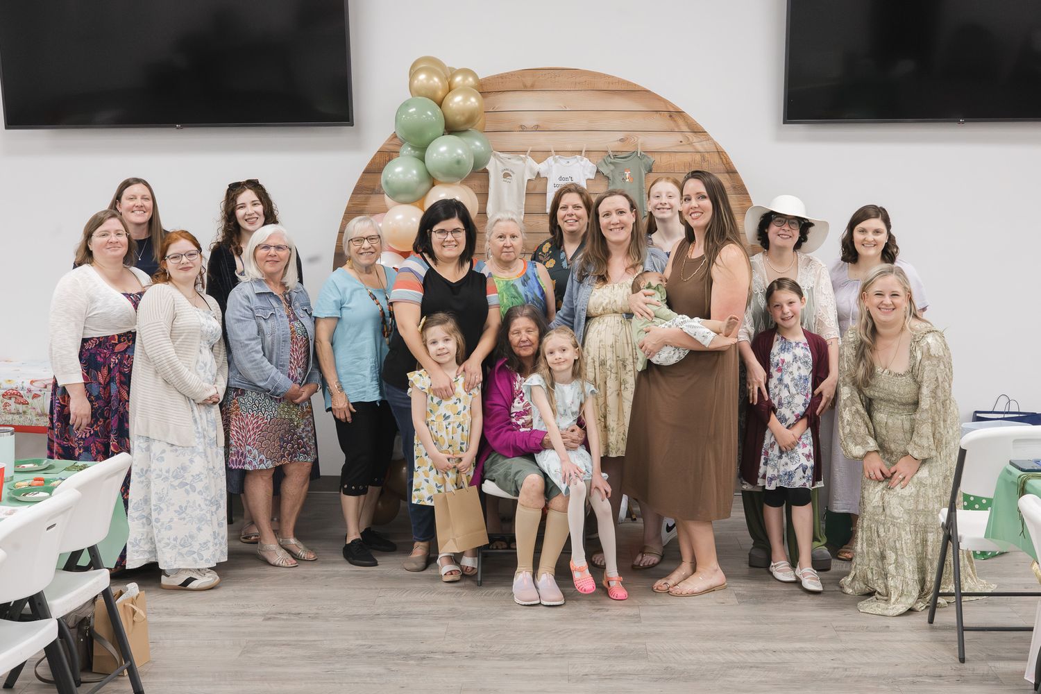 Group photo of guests at a woodland-themed baby shower in Pensacola, FL