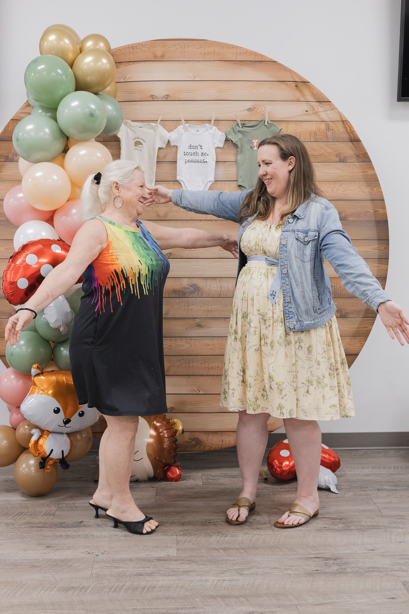 Guests celebrating in front of a balloon arch at a baby shower