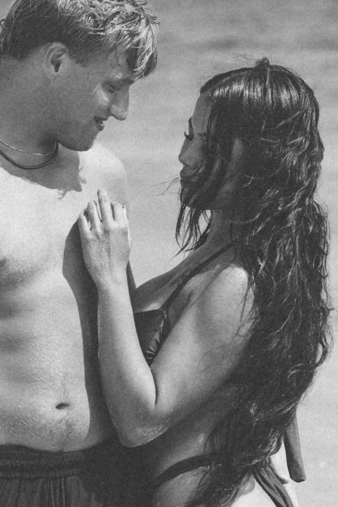 Black and white close-up of a couple in the surf
