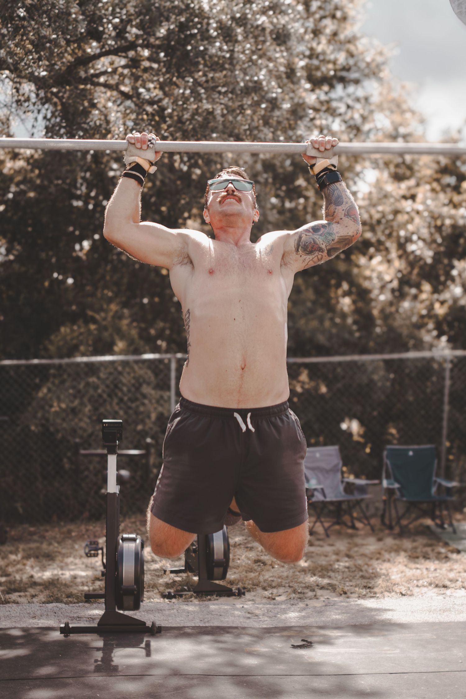 Man doing pull-ups on an outdoor rig