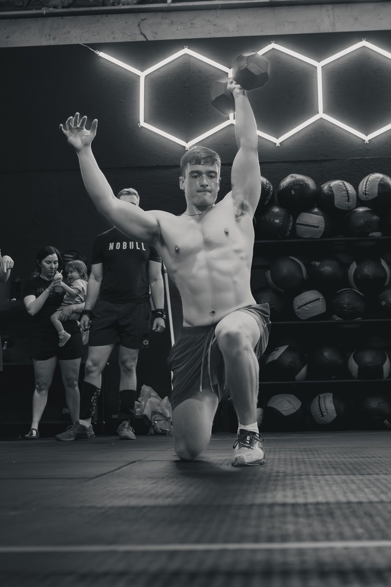 Athlete celebrating with arms raised after finishing a workout