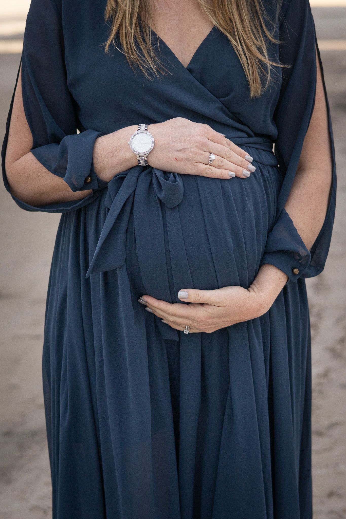 Close-up of an expecting mom's hands on her baby bump
