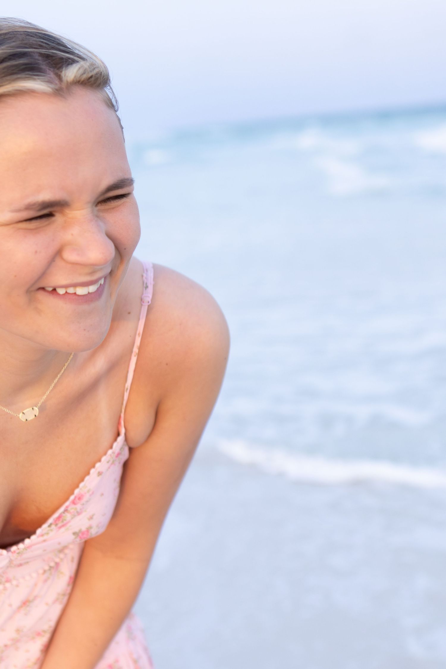 Close-up of a smiling young woman by the water
