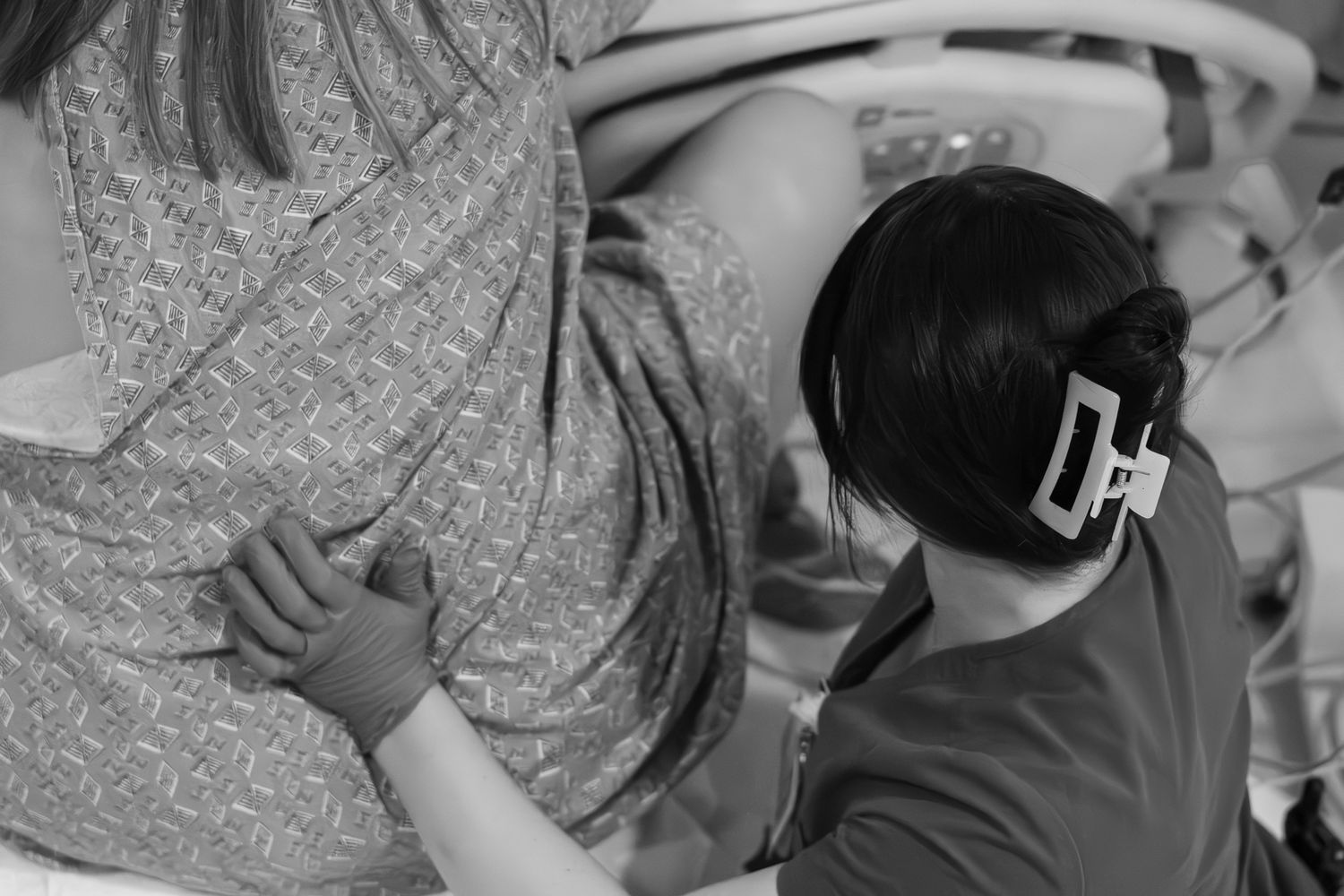Black and white photo of a nurse caring for a newborn