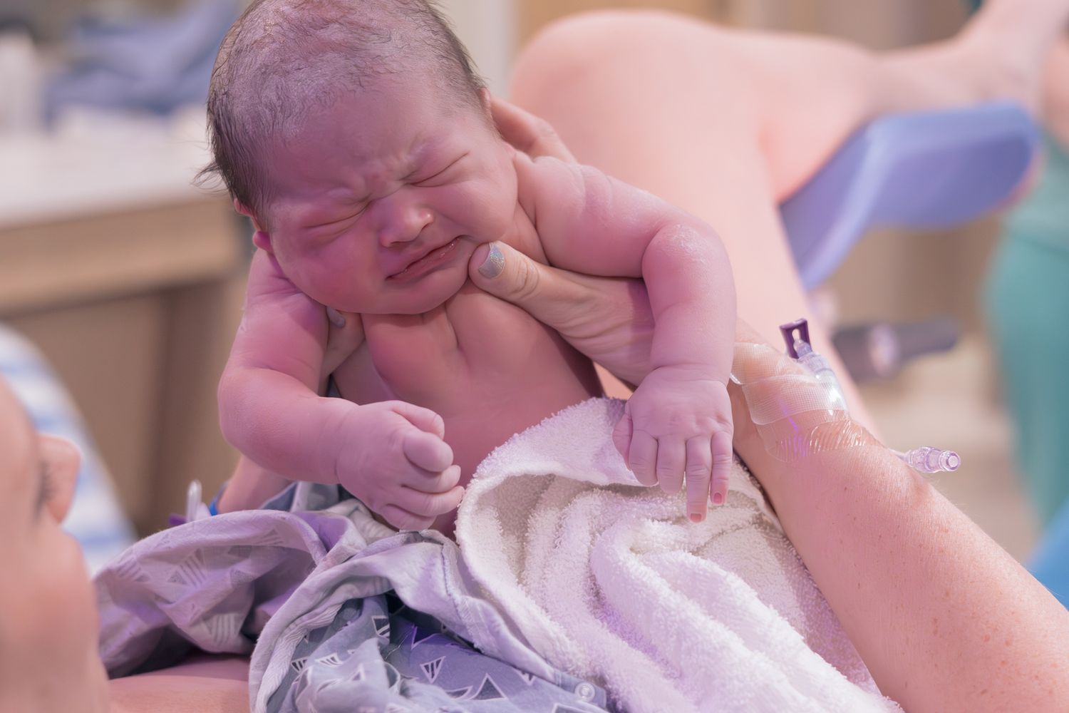 Newborn baby resting on mom's chest moments after delivery