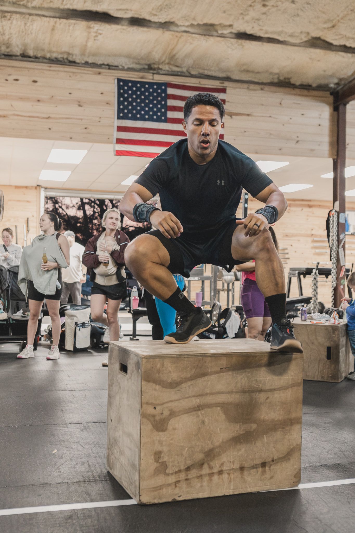 Man jumping onto a plyo box at a CrossFit gym