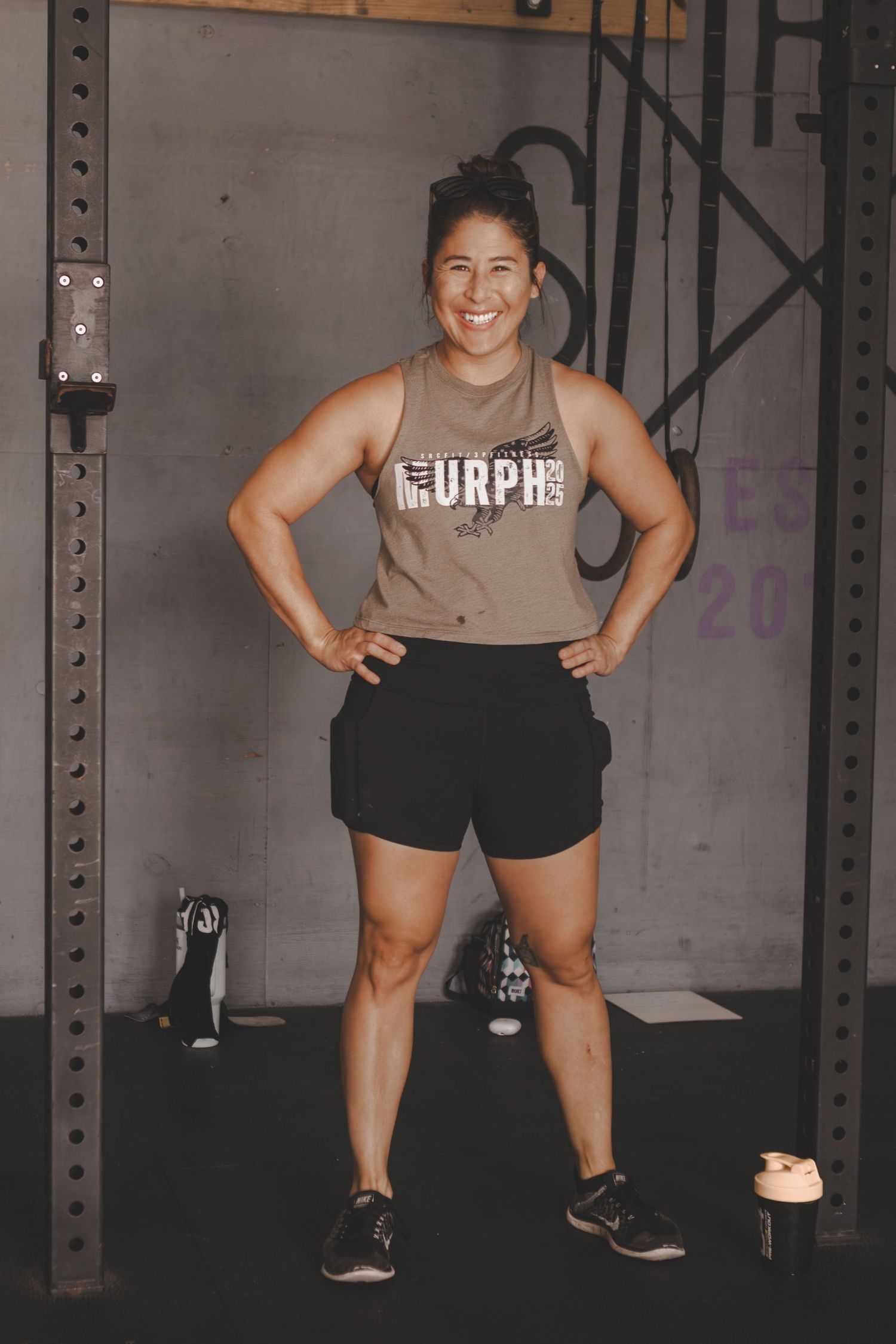 Smiling woman standing in a gym after a workout