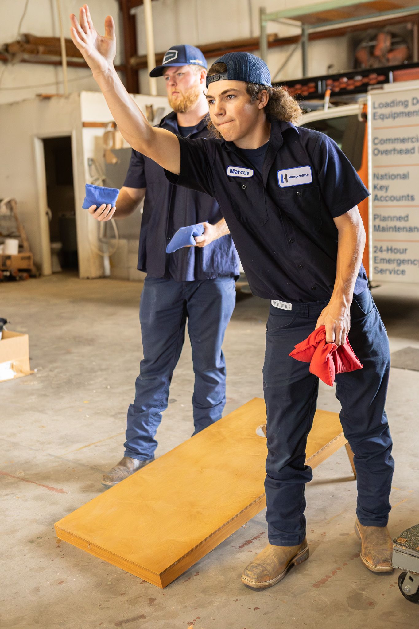 Coworkers playing cornhole at a company event in Pensacola, FL