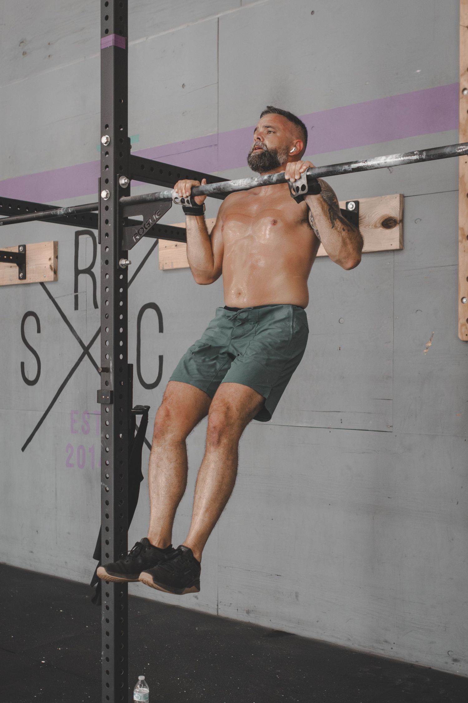Man doing a pull-up at a CrossFit gym