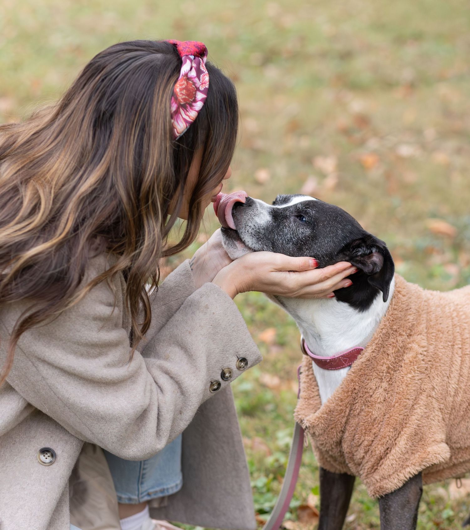 Woman touching noses with her dog for a sweet pet portrait