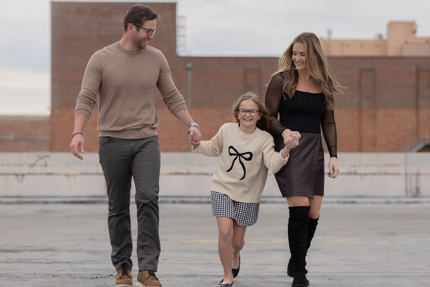 Family walking hand in hand on a downtown rooftop