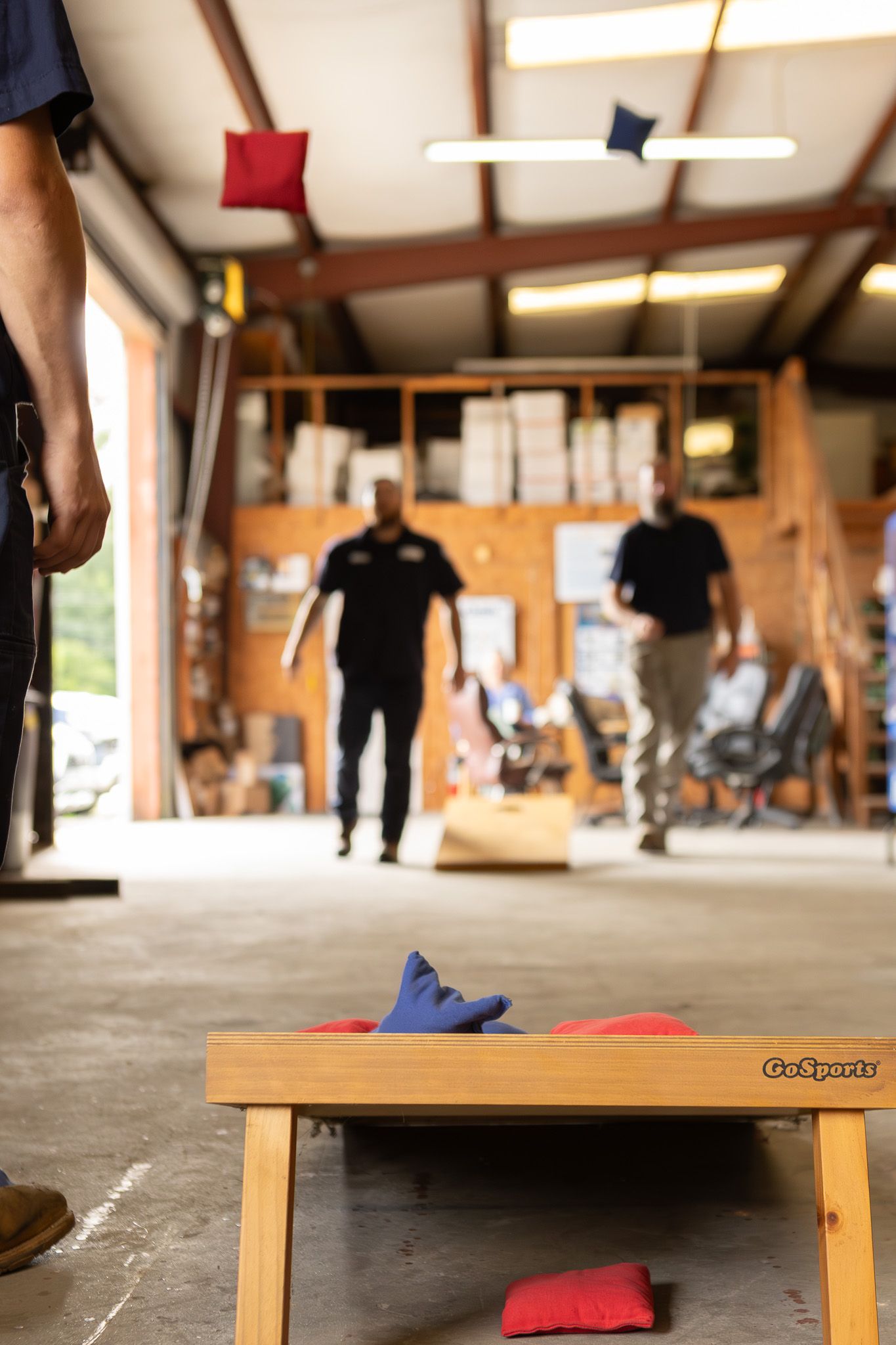Cornhole game set up in a warehouse during a company event