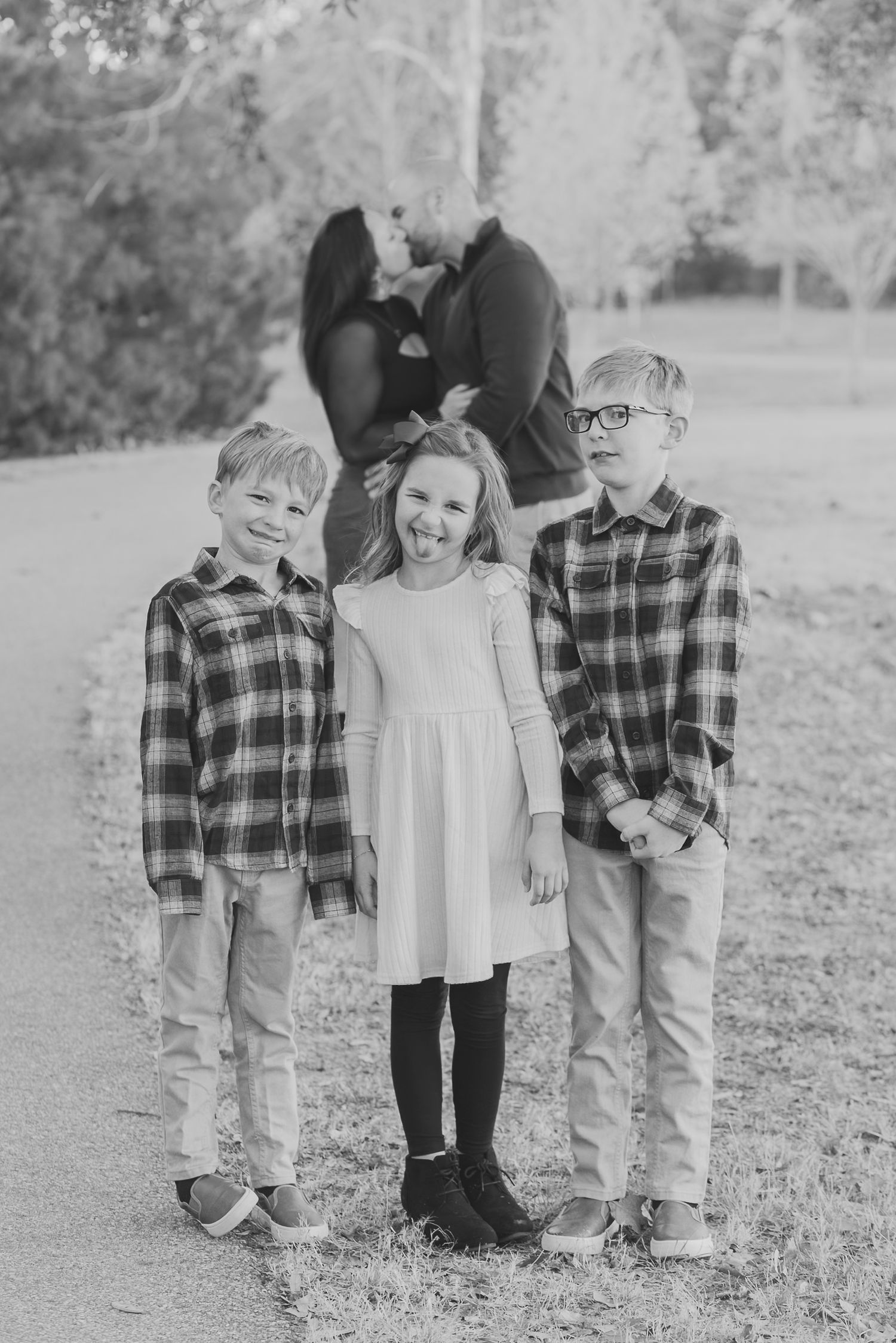 Black and white photo of a family laughing together outdoors