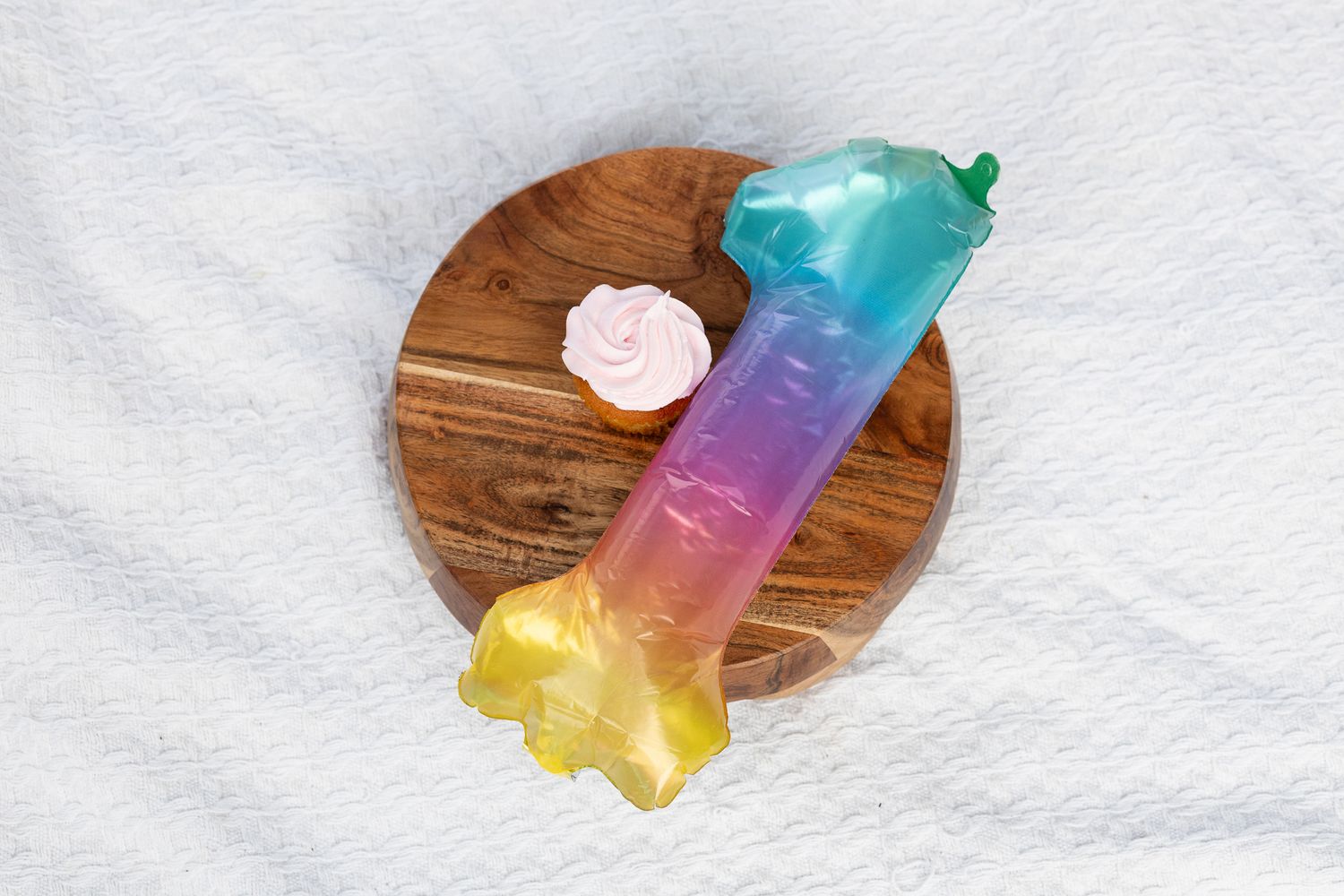 Colorful rainbow novelty item on a round wooden board