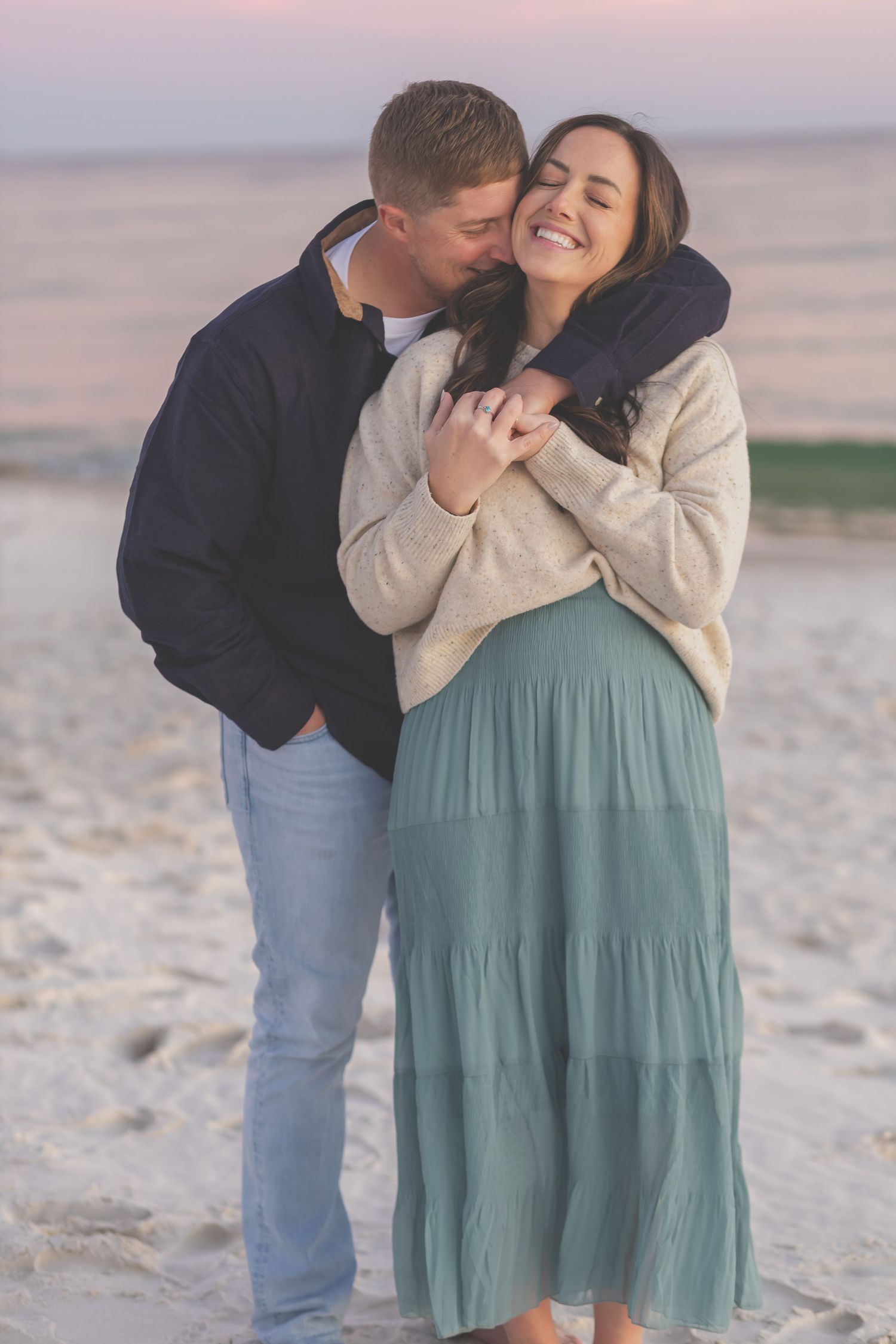 Couple embracing and smiling on Pensacola Beach