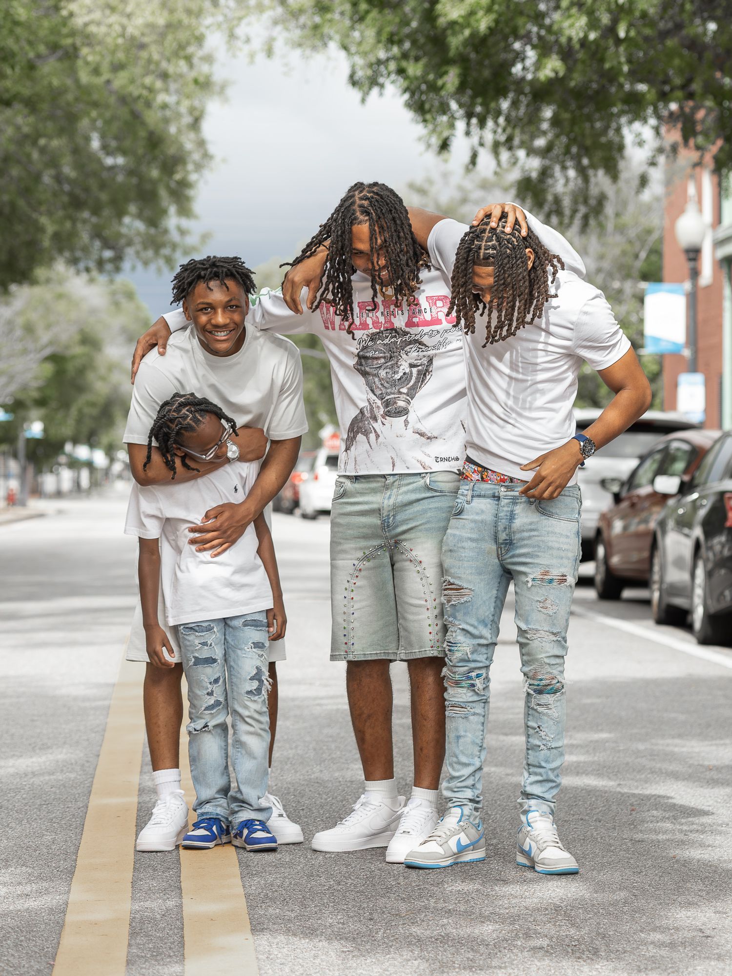 Family of five posing together on a street in downtown Pensacola, FL
