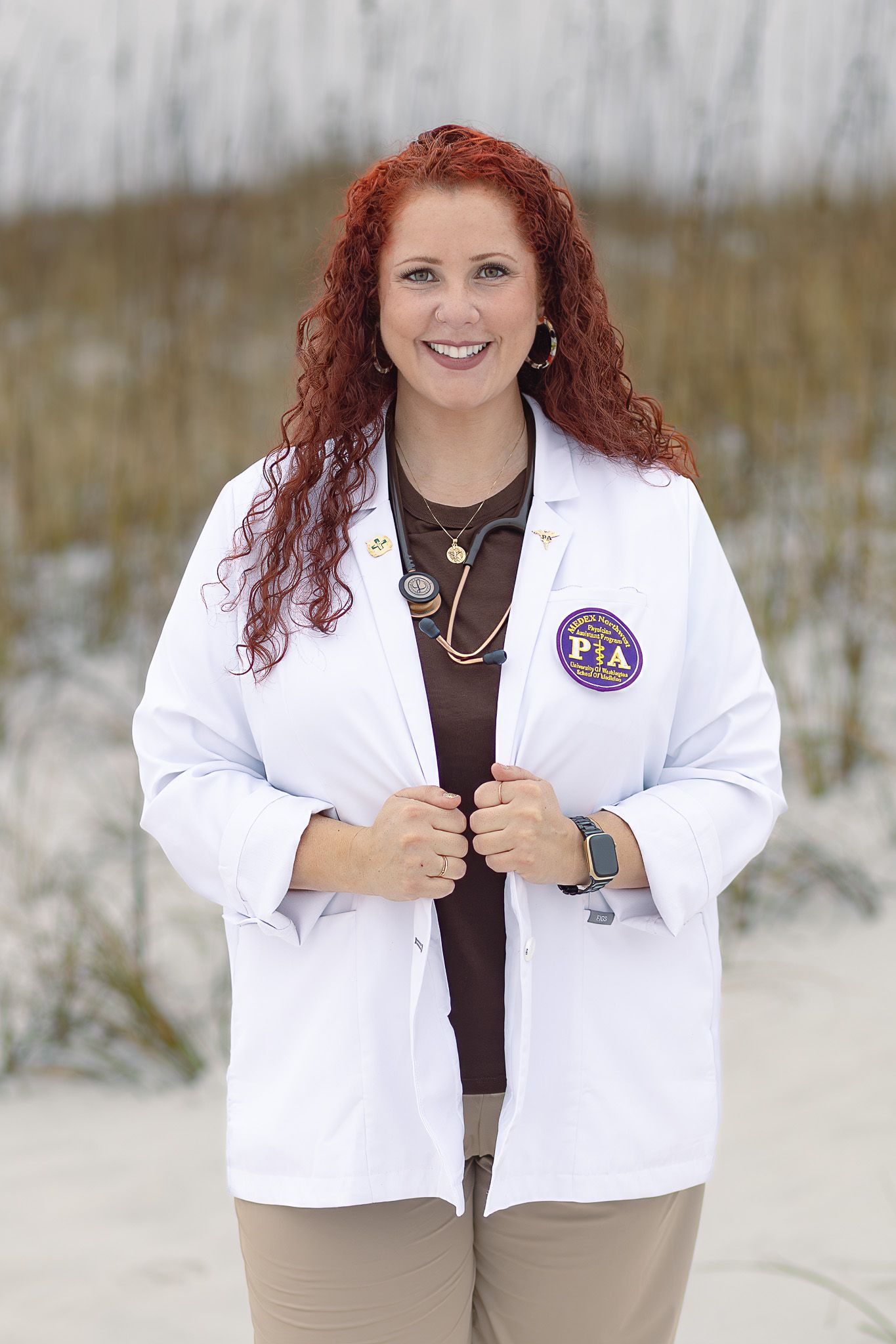 New graduate in her white coat on the beach, graduation milestone photos