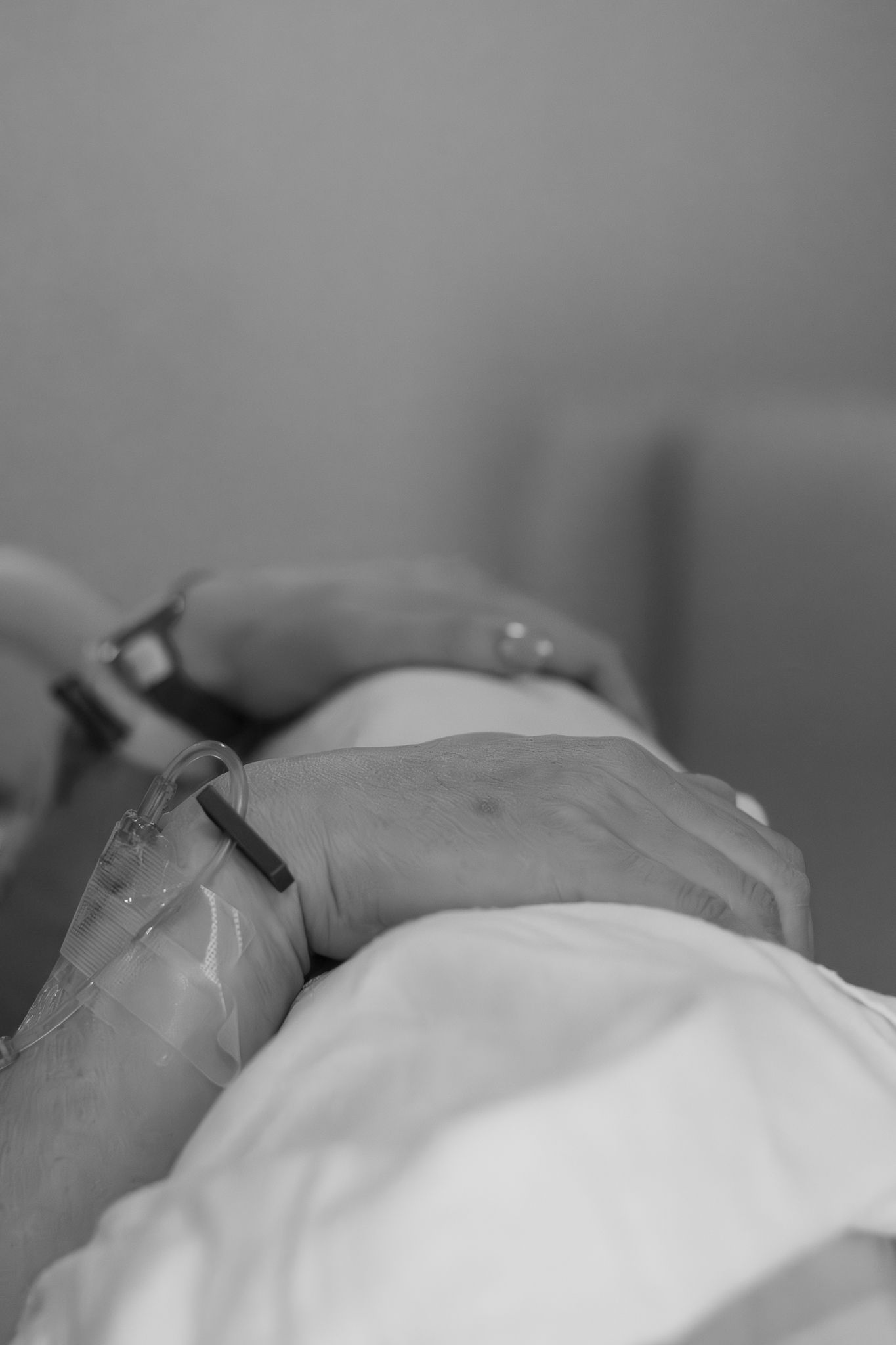Black and white close-up of hands during labor