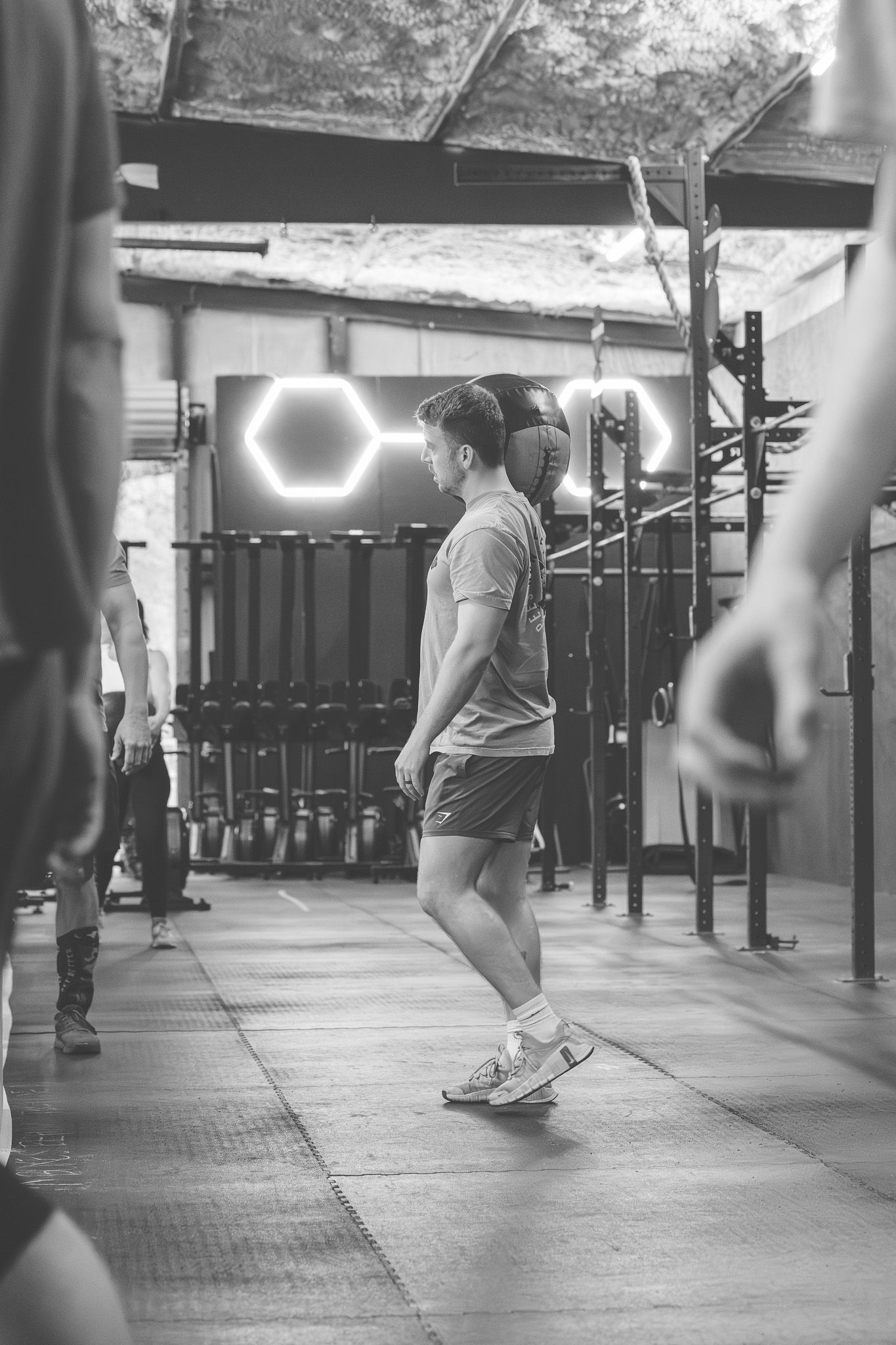 Black and white photo of an athlete moving through a gym workout