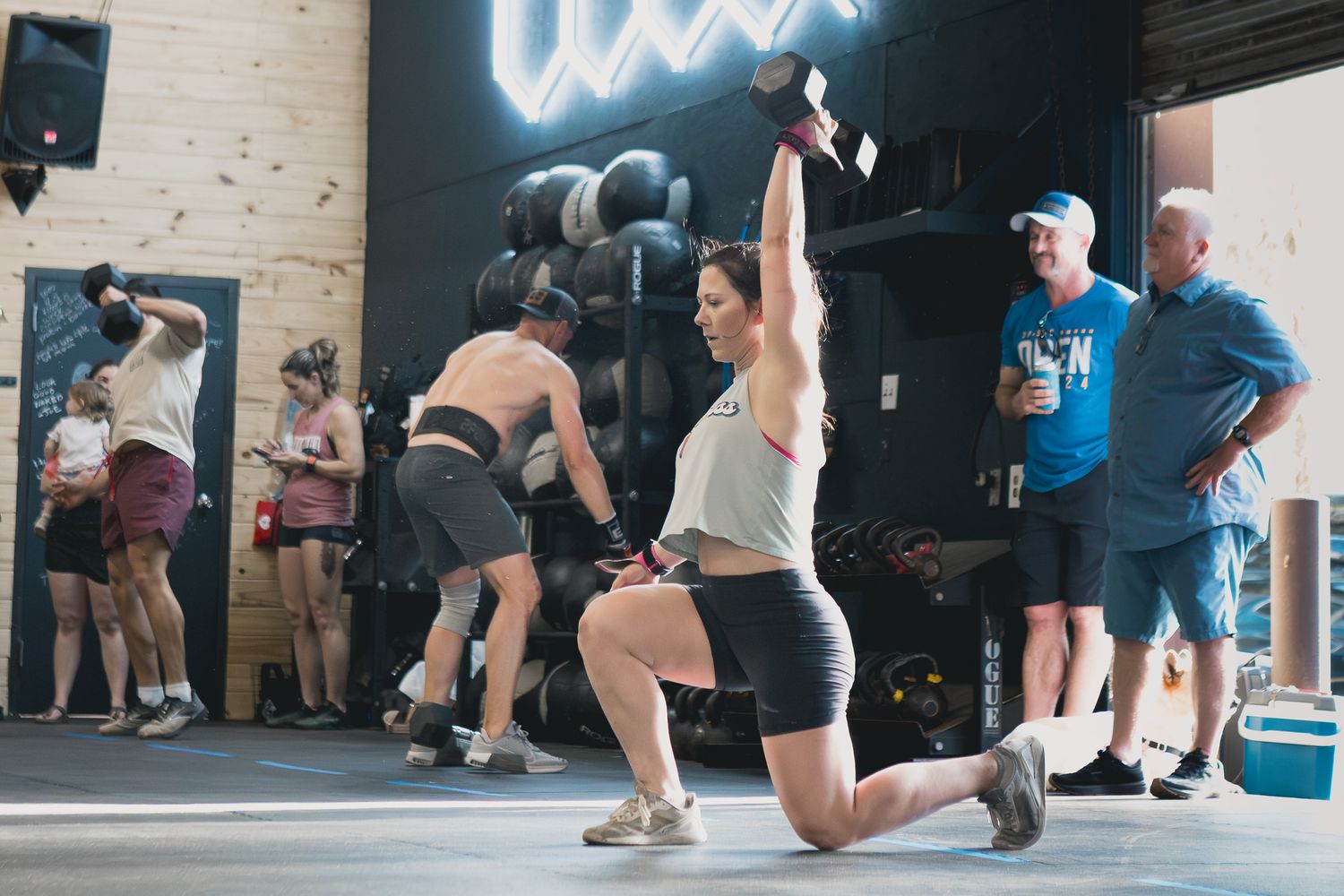 Athletes doing lunges during a group workout at a local gym