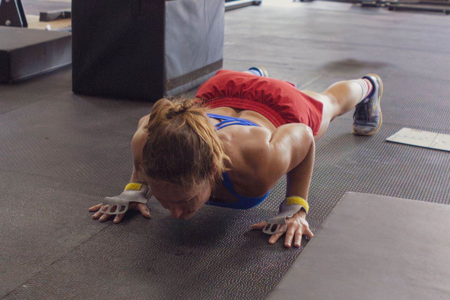 Athlete doing a burpee on the gym floor