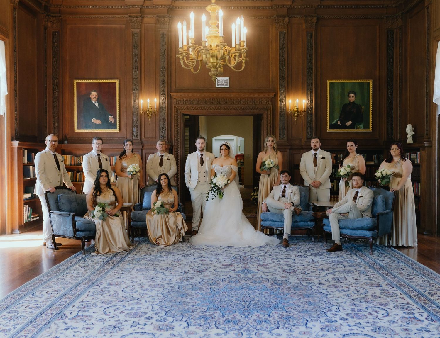 Wedding party portrait in elegant wood-paneled room with bride, groom, bridesmaids and groomsmen. editorial Kohl Mansion, California