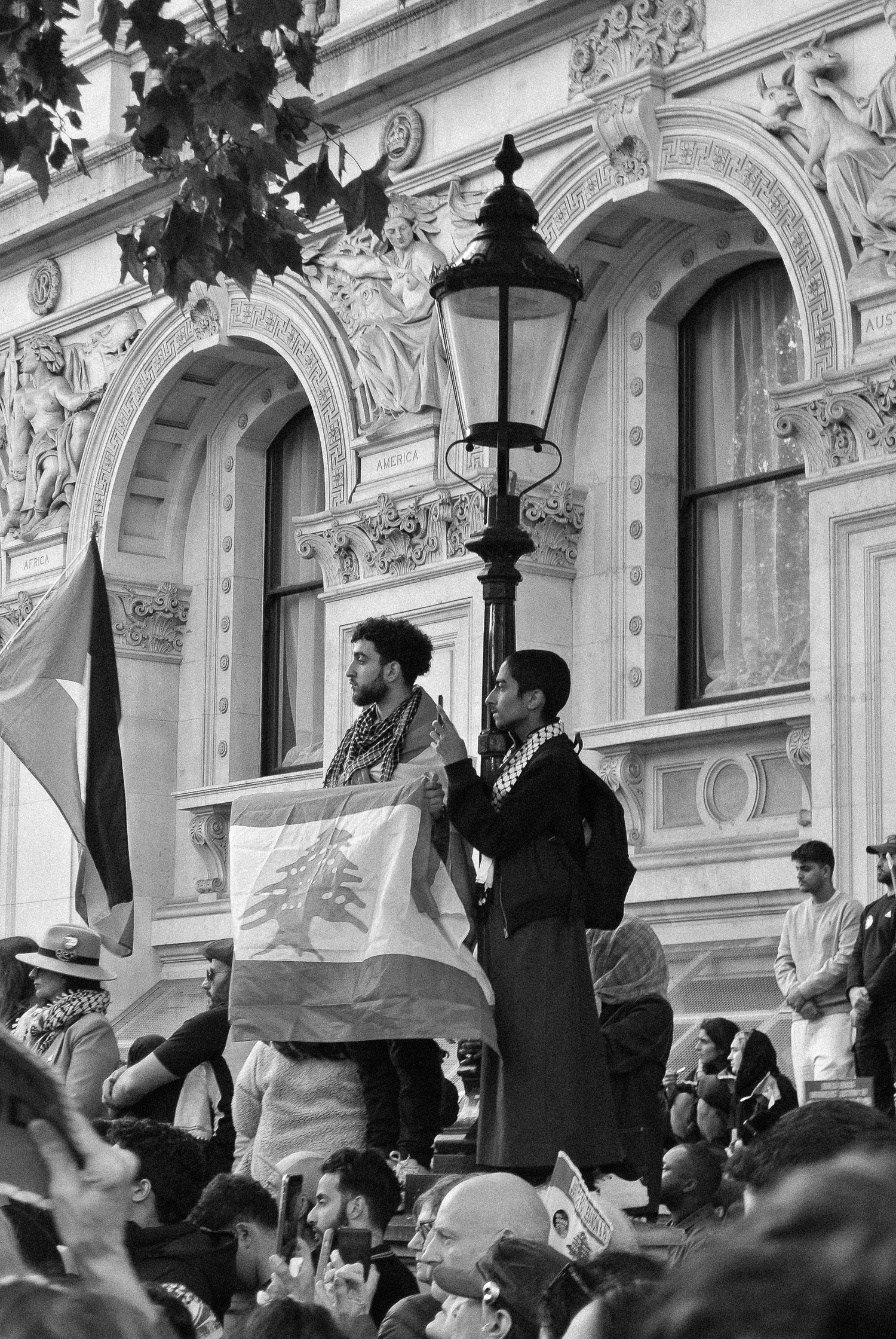 Flag of Lebanon being held during a Palestine demonstration, London