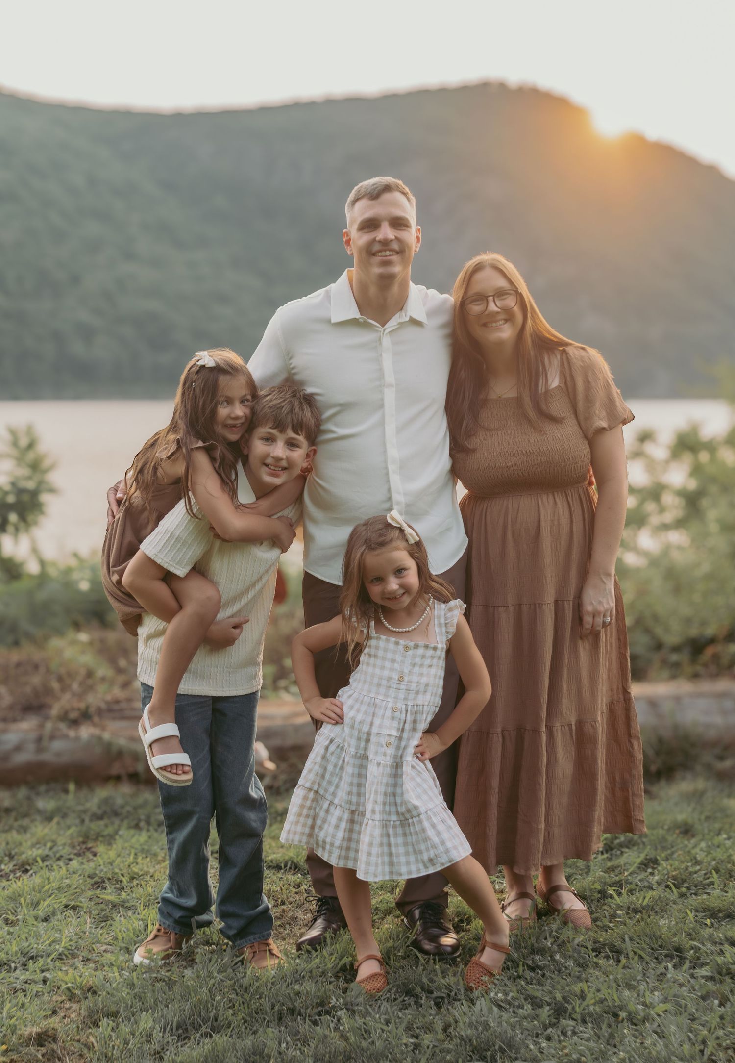 Sunset family portrait at Hudson Valley park, featuring warm, candid storytelling. Captured by Nichole JG Photography in Hudson Valley
