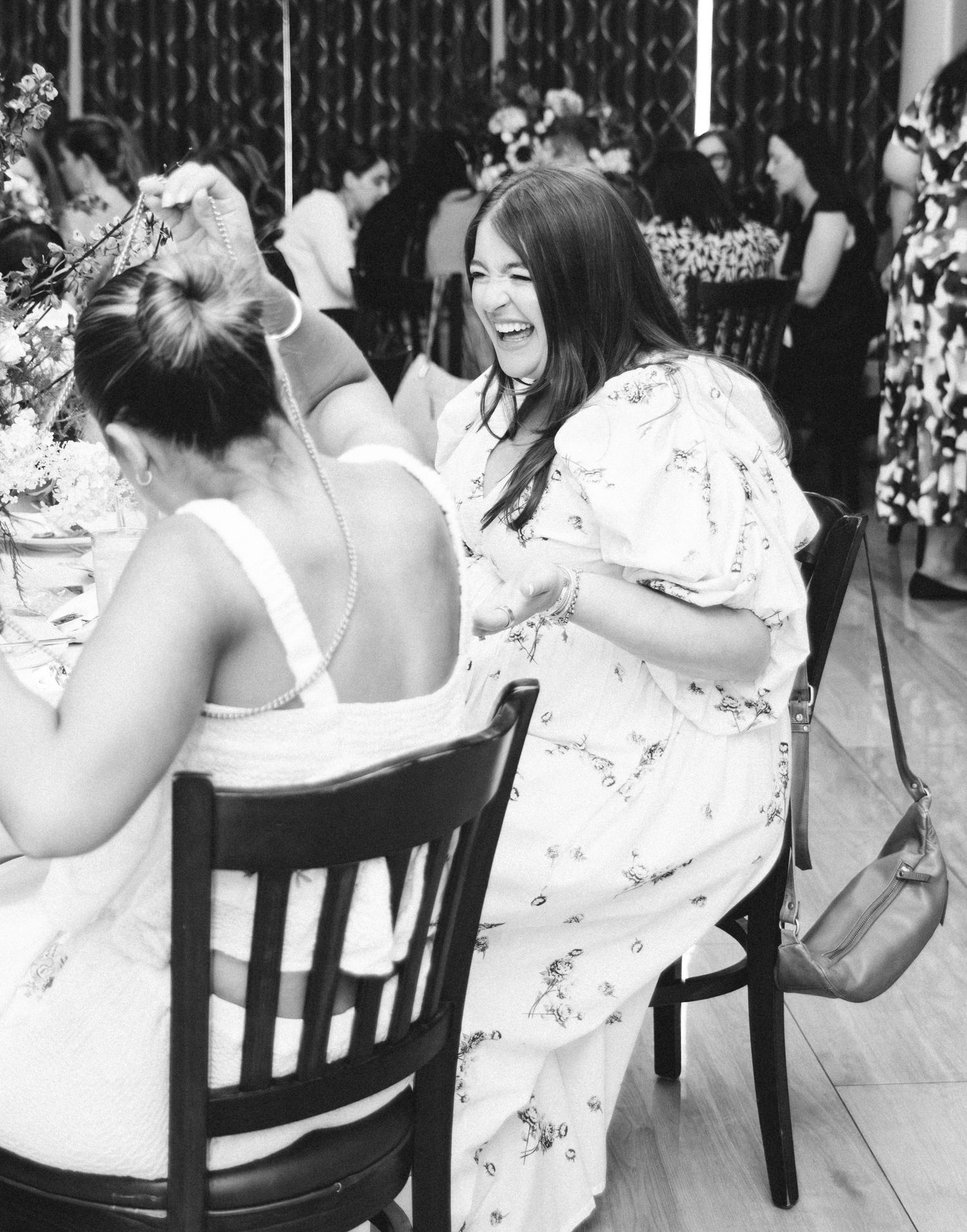 B&W event photo of guests celebrating in Hudson Valley venue, candid & inclusive. Captured by Nichole JG Photography.