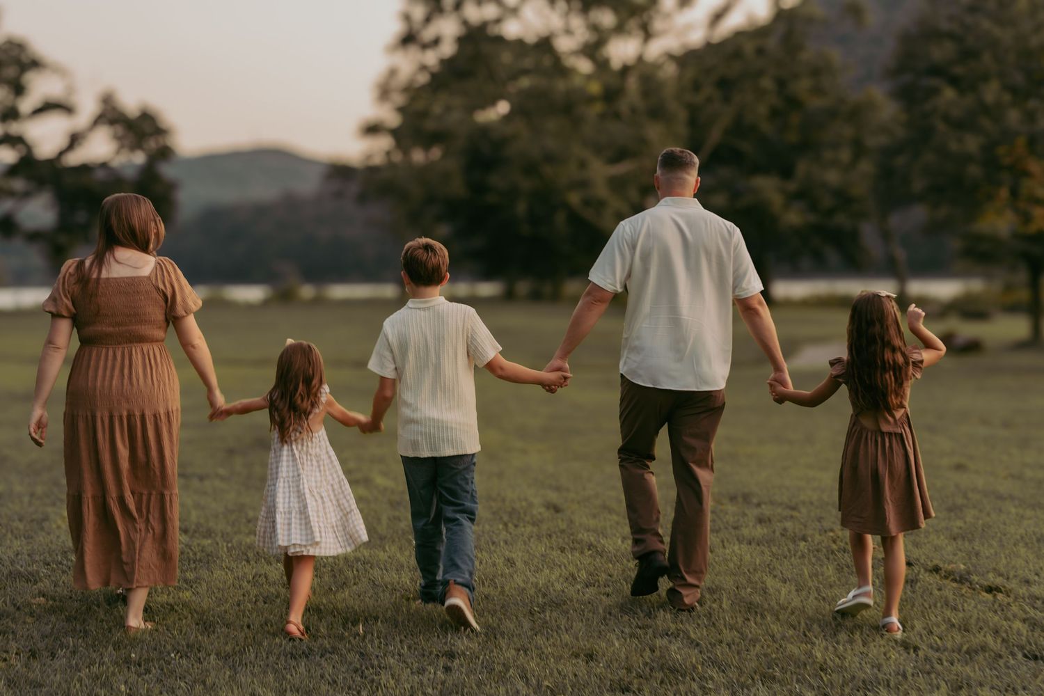 Sunset family portrait at Hudson Valley park, featuring warm, candid storytelling. Captured by Nichole JG Photography in Hudson Valley